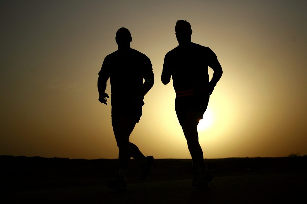 Early morning run in silhouette showing men using fitness to strengthen mindset and self-esteem