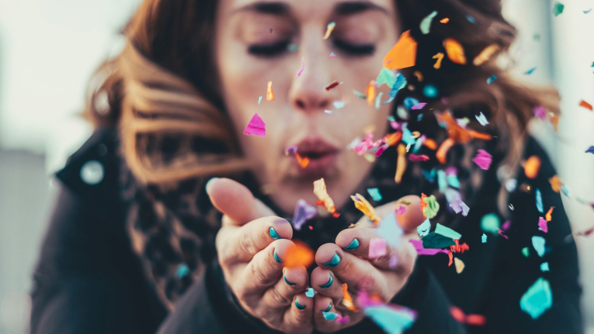 Going fit in mind, body, & connections with woman blowing confetti out of her hands scaled