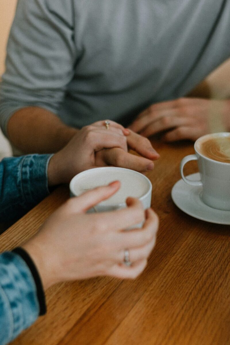 The surprising truth about modern dating culture with couple dating holding hands drinking coffee
