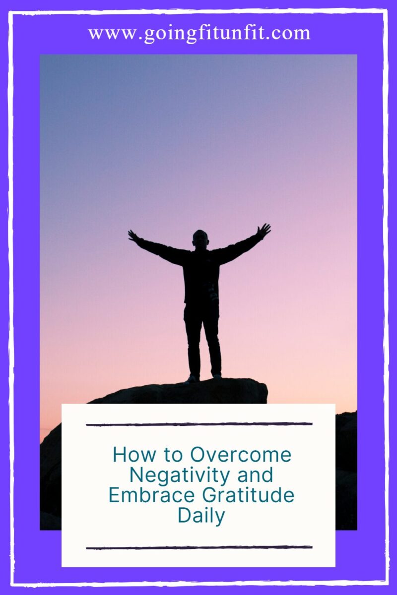 Man standing on a hill with arms spread out in gratitude