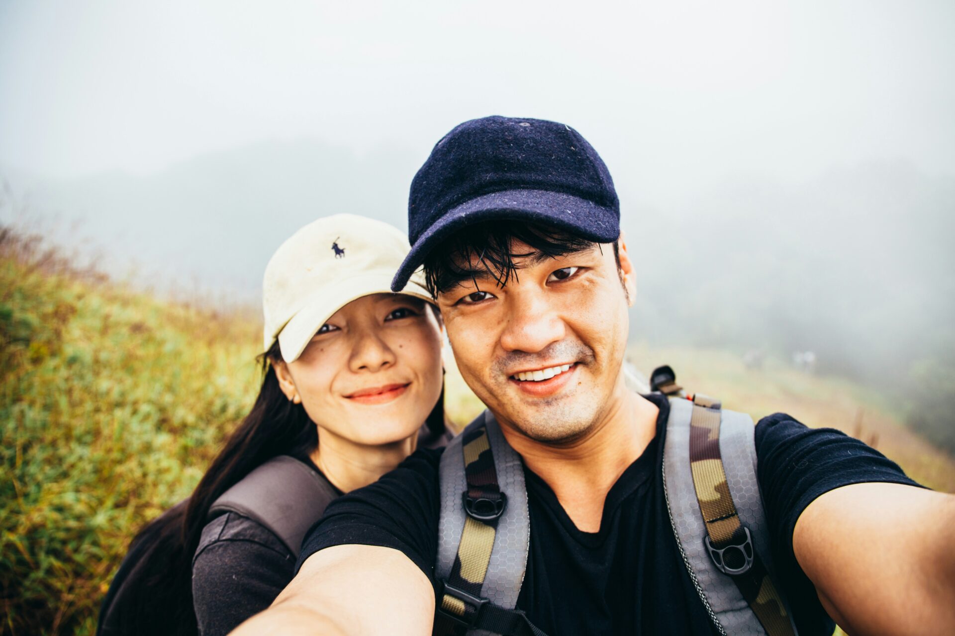 Happy married couple following couples exercise plan while hiking on farm trail together