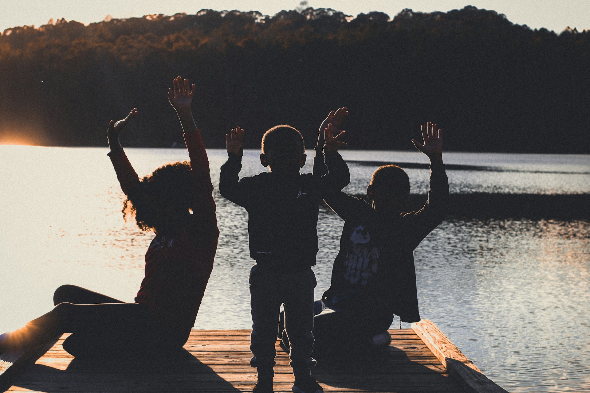 Kids having fun dancing together by the water for active family play